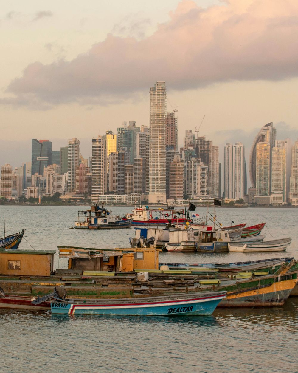 Barcas de pescadores con los rascacielos de la ciudad al fondo